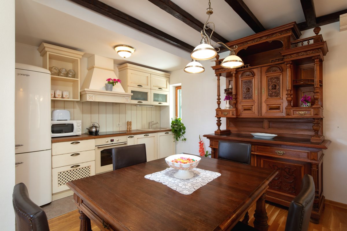 Traditional Dalmatian kitchen with the wooden elements and wooden ceiling beams in the Villa Vjeka